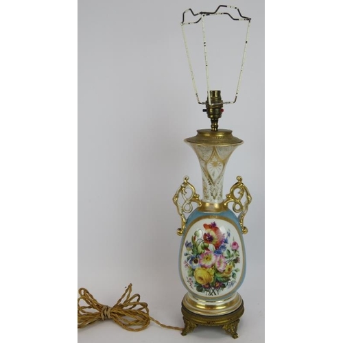 213 - A hand decorated French porcelain lamp with gilt lobes and Ormulu mounts. Height without shade 47cm.... 