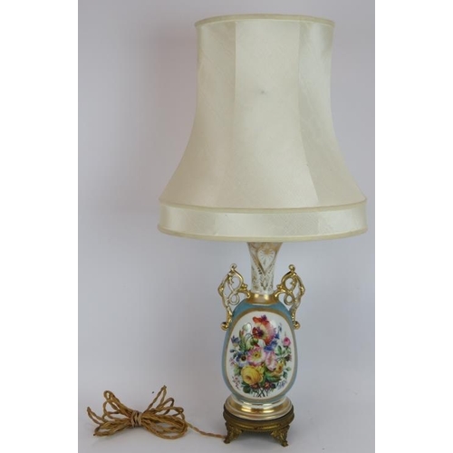 213 - A hand decorated French porcelain lamp with gilt lobes and Ormulu mounts. Height without shade 47cm.... 