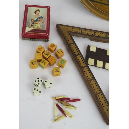 224 - A mixed lot of collectable games including playing cards, solitaire board, cribbage board, whist mar... 