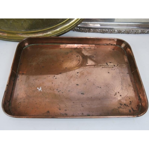 230 - Two large silver plated serving trays, one raised on four feet, plus an engraved copper tray. Larges... 