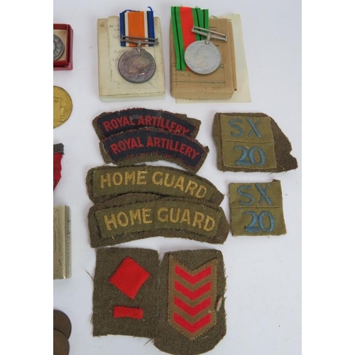 252 - A collection of mainly WWII era medals, badges, coins and related items including Boy Scouts badges ... 