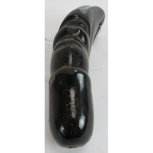 276 - A carved Buffalo horn Phallus, containing a face within the shaft, and other detail, length 19cm.
Pr... 