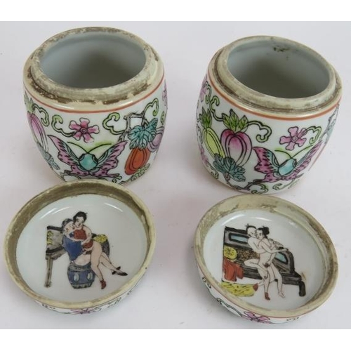 291 - A pair of small hand decorated Chinese covered jars, each with an erotic scene painted inside the li... 