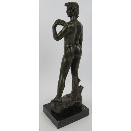 3 - A bronze figure of David After Michelangelo mounted on a black marble base, unsigned. Height 38.5cm.... 