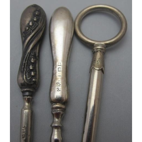 304 - A large collection of silver handled manicure items, three silver handled button hooks, all fully ha... 