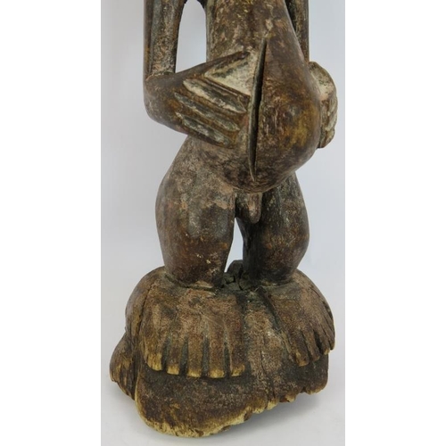 32 - A 19th Century carved African Songye power figure, Democratic Republic of Congo. Carved wood with ap... 