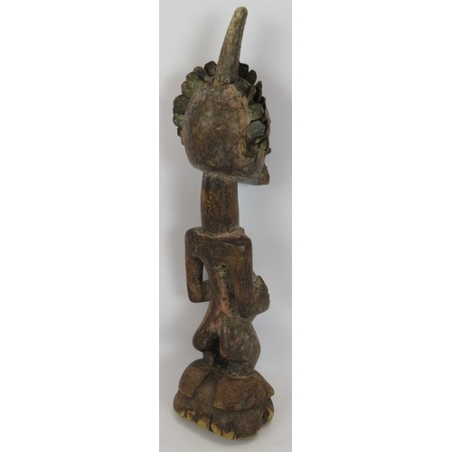 32 - A 19th Century carved African Songye power figure, Democratic Republic of Congo. Carved wood with ap... 