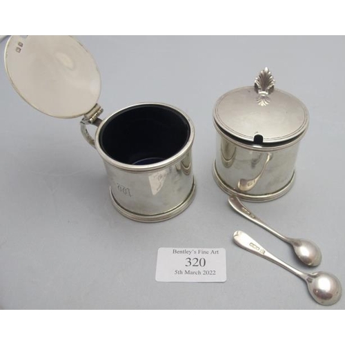 320 - A pair of silver drum shaped mustard pots with blue liners, Birmingham 1937, Asprey's London, and tw... 