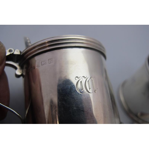 320 - A pair of silver drum shaped mustard pots with blue liners, Birmingham 1937, Asprey's London, and tw... 