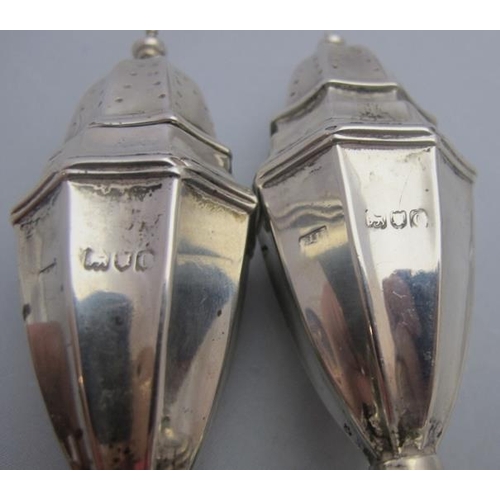 322 - A pair of silver classical shaped peppers, London 1898, engraved with griffin. Approx weight 2.6 tro... 