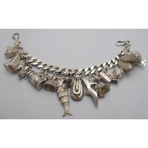 331 - A large silver curb link bracelet with 20 charms, bracelet marked 925 and some charms marked 925. Ch... 