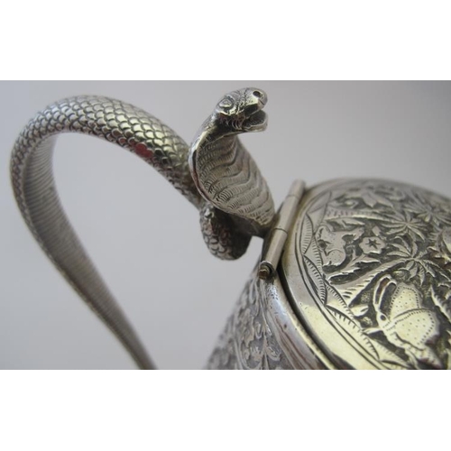 344 - A good quality Indian hot water jug with a coiled cobra handle. The body heavily embossed with anima... 