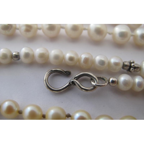 348 - A long string of individually knotted pearls, approx 30