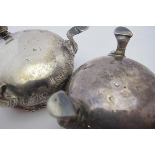 372 - A pair of Georgian silver circular salts on pad feet & embossed foliate decoration, gilded interior,... 