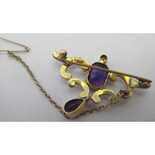 388 - A 15ct yellow gold brooch set with centre amethyst & drop amethyst and with scroll set seed pearls, ... 