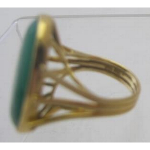 394 - An 18ct yellow gold ring set with large oval green stone, approx 25mm x 15mm, size M, approx weight ... 