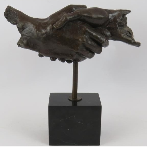 4 - A bronze sculpture of clasped hands mounted on a black marble plinth unsigned. Height 35cm.
Conditio... 