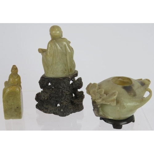 40 - A carved hardstone Chinese figure of a scholar, a similar Chinese seal and a carved hardstone oil la... 