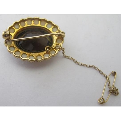 418 - A 9ct yellow gold brooch set with centre citrine and surrounded with seed pearls with safety chain. ... 