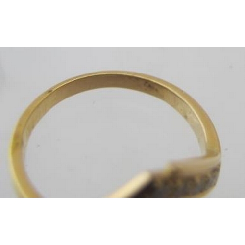 432 - An 18ct yellow gold ring, set with a band of nine diamonds in a 'V' shape design, size M, approx wei... 