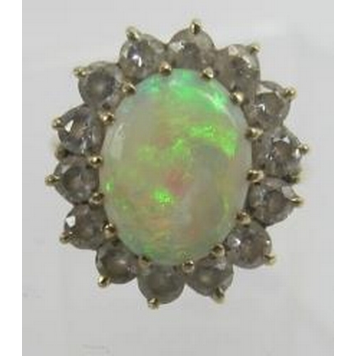 435 - A gold, opal & diamond cluster ring, opal approx 12mm x 10mm, surrounded by 14 brilliant cut diamond... 