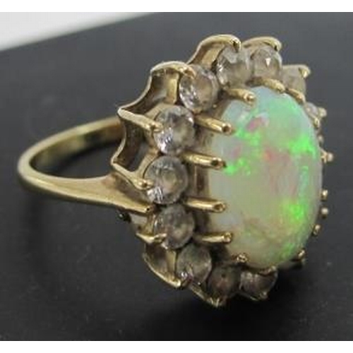 435 - A gold, opal & diamond cluster ring, opal approx 12mm x 10mm, surrounded by 14 brilliant cut diamond... 