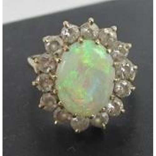 435 - A gold, opal & diamond cluster ring, opal approx 12mm x 10mm, surrounded by 14 brilliant cut diamond... 