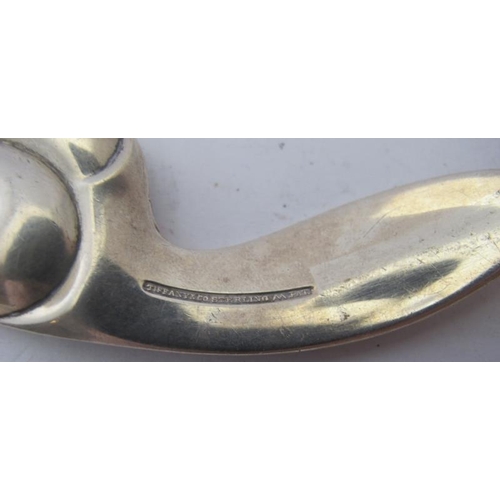 437 - A Tiffany & Co stamped caddy spoon, with swirl decoration, stamped sterling.
Condition report: Some ... 