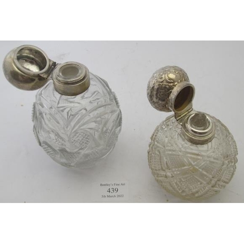 439 - Two scent bottles, one stopper missing, both with cut glass bodies on geometric patterns, one Birmin... 