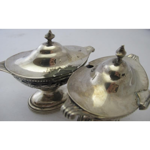 441 - A pair of pedestal hinged salts with pierced decoration & blue liners, Birmingham 1910.
Condition re... 