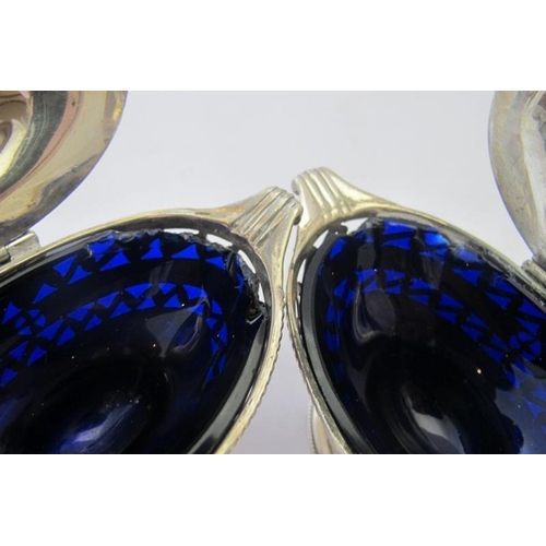 441 - A pair of pedestal hinged salts with pierced decoration & blue liners, Birmingham 1910.
Condition re... 