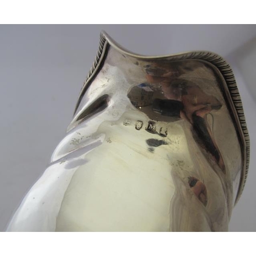 447 - A Georgian silver cream jug on ball feet, London 1807, approx weight 5.8 troy oz/184 grams.
Conditio... 