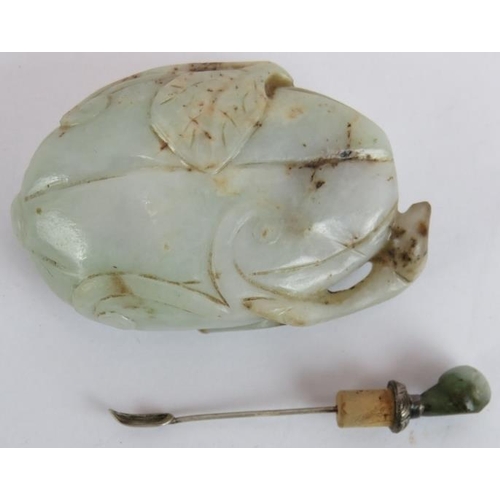 45 - A Chinese celadon & russet carved jade snuff bottle of melon form with white metal spoon. Length 8.5... 