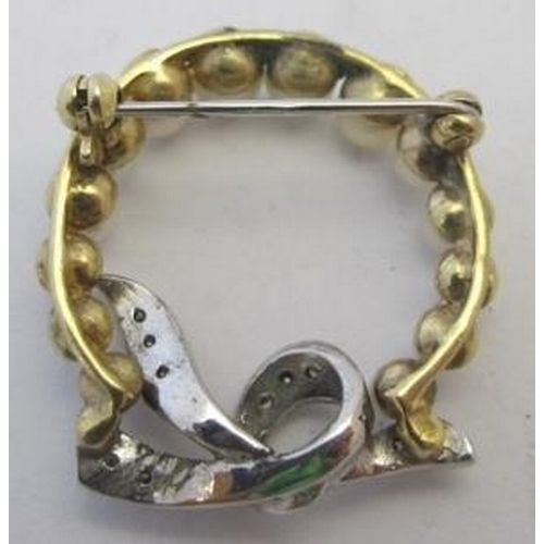 489 - An unmarked yellow and white metal brooch set with 14 graduated pearls bought together with a bow se... 