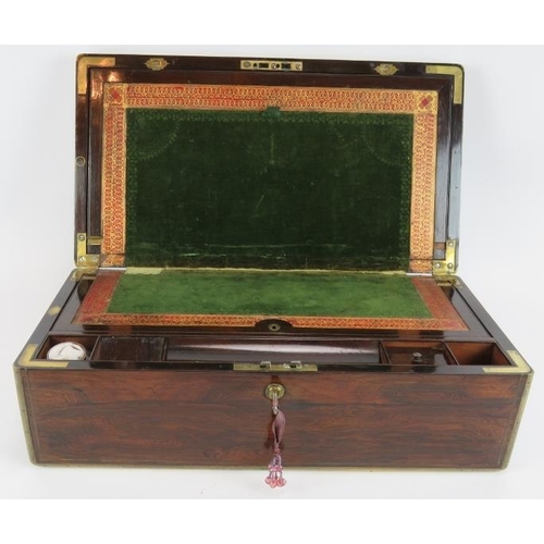 54 - A 19th Century brass bound rosewood writing slope with working Bramah lock, flush handles and docume... 