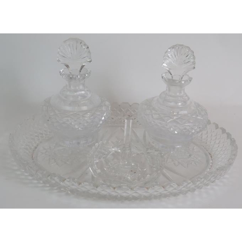 64 - A four piece cut crystal dressing table set, three similar covered jars, a cut glass candlestick and... 