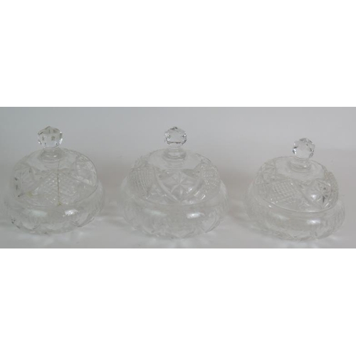 64 - A four piece cut crystal dressing table set, three similar covered jars, a cut glass candlestick and... 