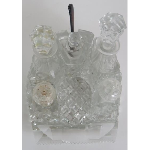 64 - A four piece cut crystal dressing table set, three similar covered jars, a cut glass candlestick and... 