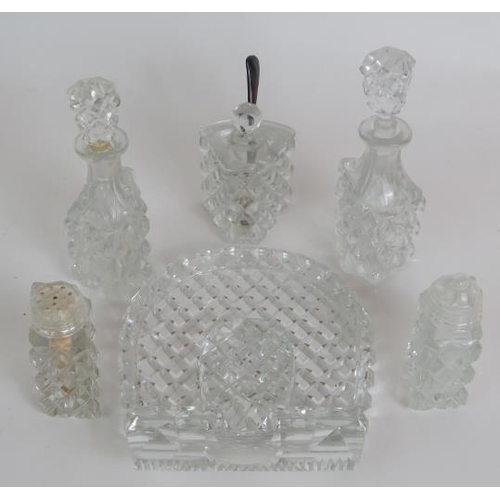 64 - A four piece cut crystal dressing table set, three similar covered jars, a cut glass candlestick and... 