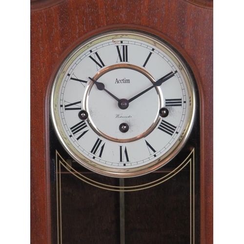 71 - An Acctim Westminster chiming wall clock in mahogany case. Key & pendulum present. Height 47cm.
Cond... 