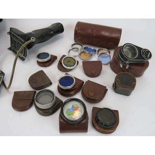 87 - A Vintage Baldamatic III camera & case with 135mm lens plus various Rolleiflex filters and accessori... 