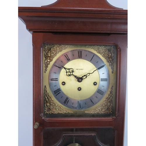 90 - A contemporary Metamec striking & chiming wall clock in mahogany style case. Pendulum & key present.... 