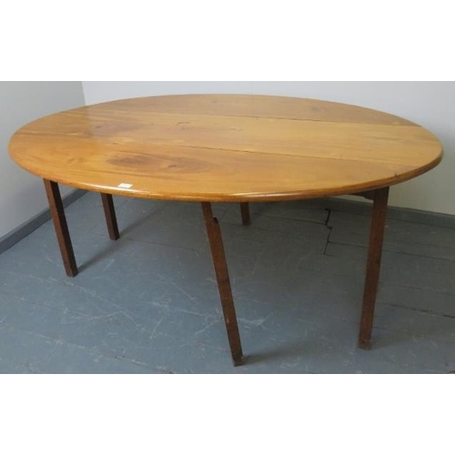 702 - A 19th century pale mahogany oval drop-leaf hunt table, on square supports. Possibly Irish. 
Conditi... 