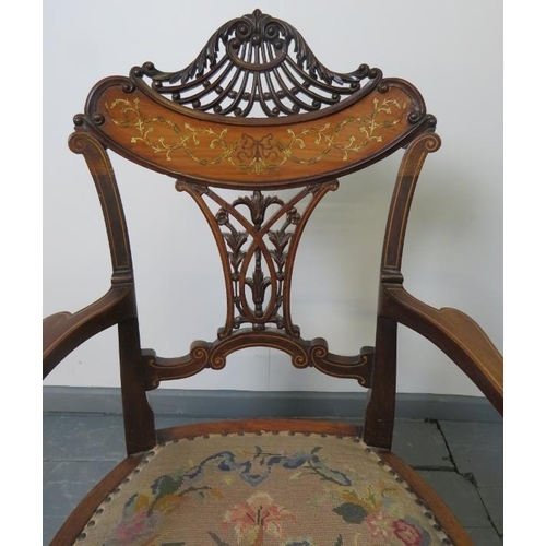 705 - A fine Edwardian mahogany elbow chair, featuring an intricately carved and pierced backrest with mar... 