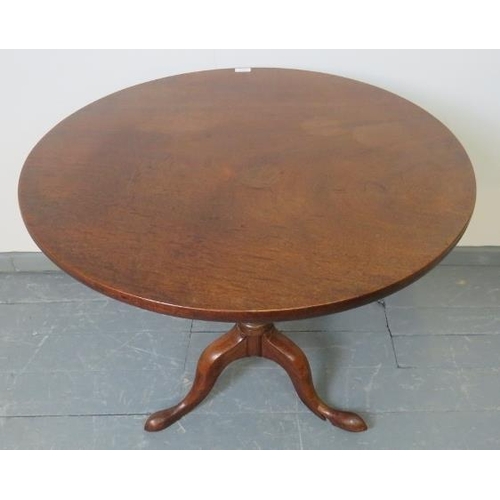 708 - A George III mahogany circular tilt-top table, on a baluster turned column with outsplayed tripod ba... 