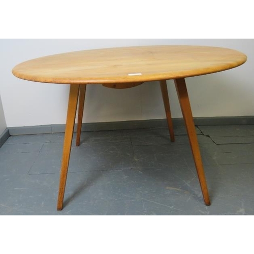 712 - A mid-century Ercol blond elm circular drop-leaf dining table, on canted tapering supports.
Conditio... 