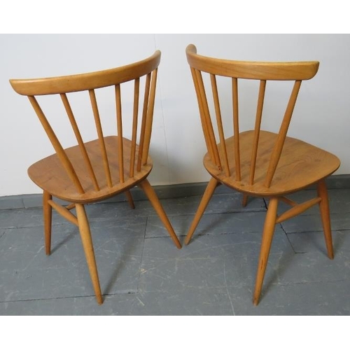 713 - A pair of mid-century Ercol blond bow top occasional chairs, model 449. With removable seat cushions... 