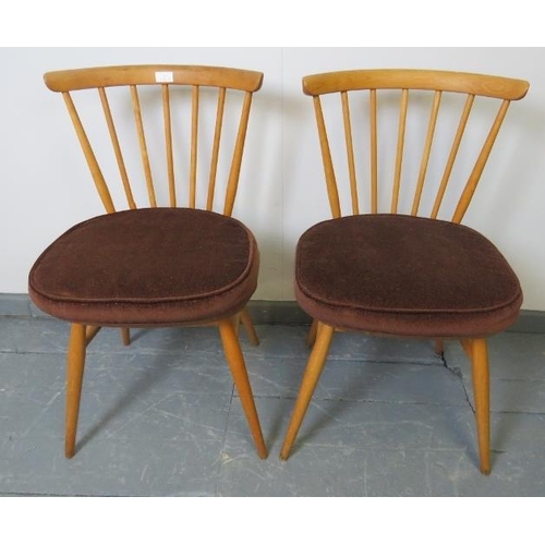 713 - A pair of mid-century Ercol blond bow top occasional chairs, model 449. With removable seat cushions... 