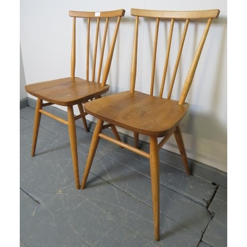 714 - A pair of mid-century Ercol blond stickback occasional chairs, model 391. With removable seat cushio... 