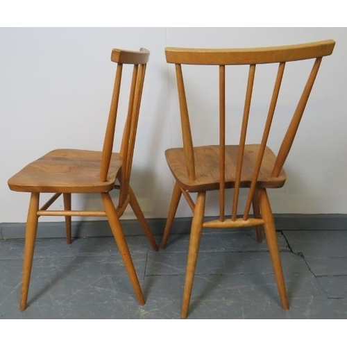 714 - A pair of mid-century Ercol blond stickback occasional chairs, model 391. With removable seat cushio... 